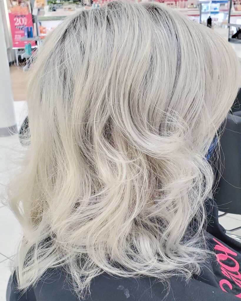 An icy blonde head of hair, perfectly blending what is naturally growing in as white with what is naturally still dark to create a beautiful white-blonde canvas. The possibilities for vivid colors are endless from here.