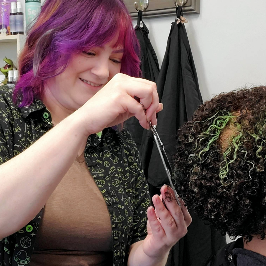 Stylist cutting curly hair dry - DevaCut Rezo Cut technique New Orleans - Wicked Hues